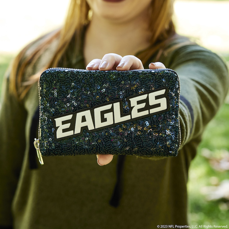 Image of woman holding the NFL Philadelphia Eagles Sequin Wallet out to camera